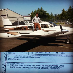 man stands on wing of multi engine airplane